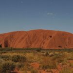 TO GO WITH STORY Australia-tourism-indigenous-Uluru,FEATURE by Madeleine Coorey
This photo taken on October 11, 2013 shows Uluru, formerly known as Ayers Rock, a large sandstone rock formation and the world's largest monolith situated in the southern part of the Northern Territory in central Australia and southwest of the nearest large town Alice Springs. Tourists to Australia are increasingly seeking an Aboriginal experience and the ancient sacred site of Uluru is on their checklist, but while the traditional Aboriginal owners do not want tourists to climb the famous red monolith, some continue to do so, prompting a debate about whether the practice should be banned.    RESTRICTED TO EDITORIAL USE  -- IMAGE MUST BE USED WITH INTENDED AFP STORY UNDER AGREEMENT WITH NATIONAL PARKS AUSTRALIA --    AFP PHOTO / Greg WOOD        (Photo credit should read GREG WOOD/AFP/Getty Images)